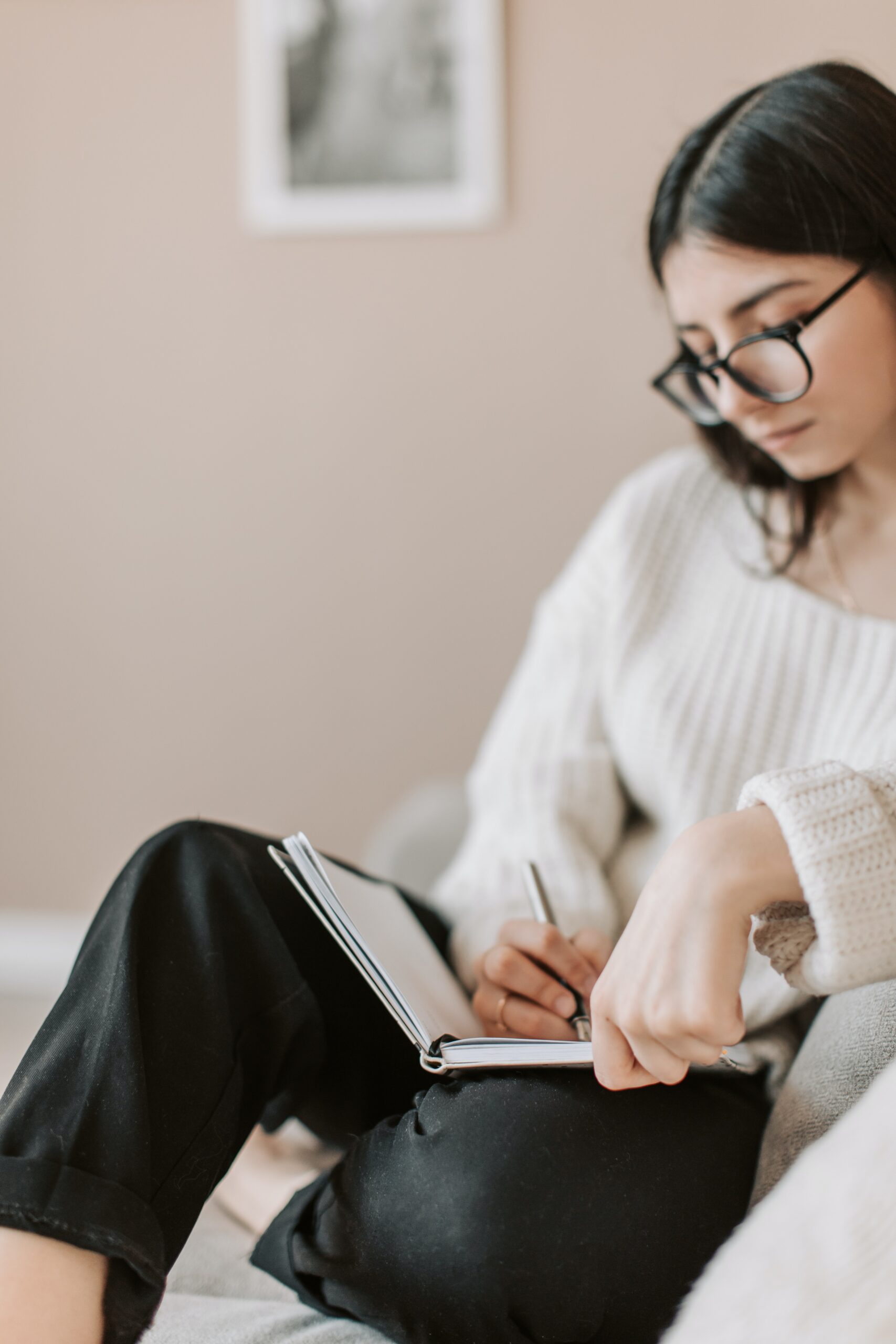 young person writing in a note book