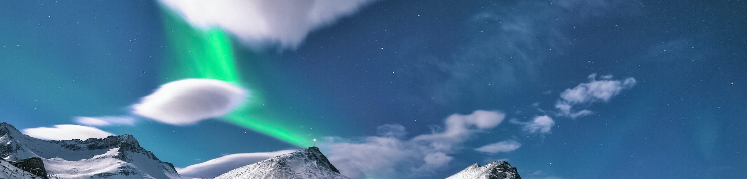 sky over snowy mountains with northern lights